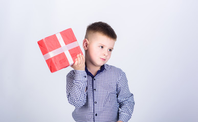 i am interested what is inside. Shopping. Boxing day. New year. Birthday party. shop assistant. Happy childhood. little boy with valentines day gift. happy child with present box. Christmas