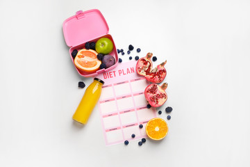 Sheet of paper with diet plan, bottle of juice and fresh fruits on white background