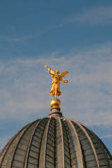 Fototapeta na wymiar Golden angel at the roof of the 