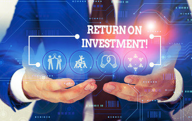 Conceptual hand writing showing Return On Investment. Concept meaning perforanalysisce measure used evaluate efficiency of investment Male wear formal suit presenting presentation smart device