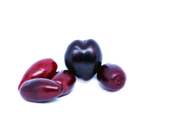 Cornus mas or Cornelian cherry fruit isolated on white background