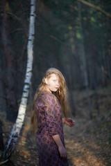 Beautiful girl with white hair in the autumn forest