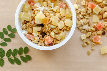 granola with candied fruit in a ceramic bowl