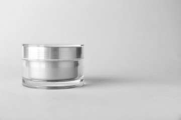 Jar of cosmetic cream on white background