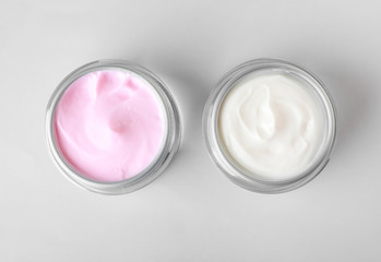 Obraz na płótnie Canvas Jars of cosmetic cream on white background
