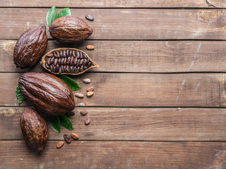 Cocoa pod and cocoa beans on the wooden table. Top view.