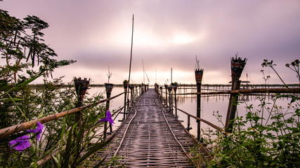 Small wooden bridge with Kwan Phayao lake at sunrise