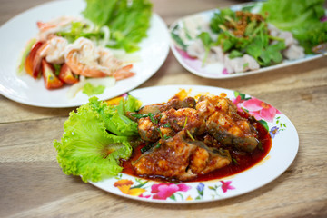 Stir-fried deep fried fish (Asian redtail catfish) with red curry paste. Thai healthy asian food from fish cooked.