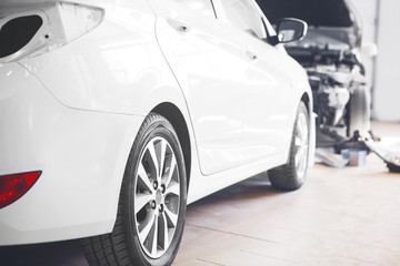 Close-up of a white car in service station, back view.
