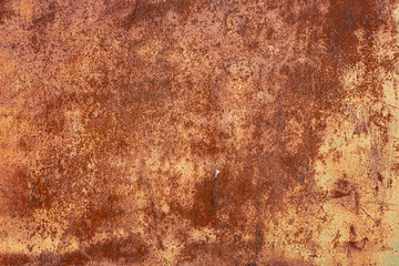 Rusty yellow-red textured metal surface. The texture of the metal sheet is prone to oxidation and corrosion. Textured background in grunge Style