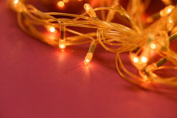 Christmas garland on a red background. lights garland closeup. space for text