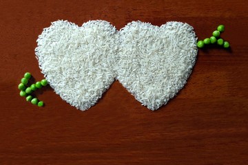 Heart shape of rice with green peas arrow with copy space. Concept of valentine and love card and background.