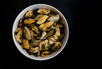 Cooked mussels isolated on black background
