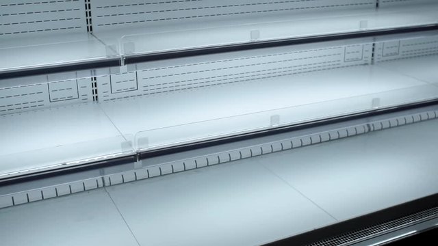Empty white shelves of the hypermarket sale of goods