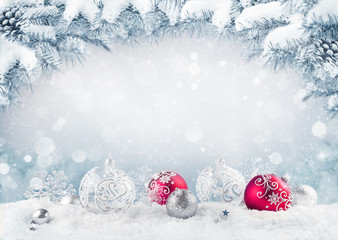 Naklejka na ściany i meble Merry Christmas card. Red christmas balls and baubles on the snow with fir branches.