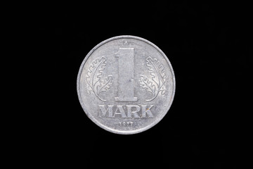 Old German Democratic Republic 1 Mark coin from 1977, reverse. Isolated on black background