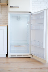 Open empty white refrigerator.