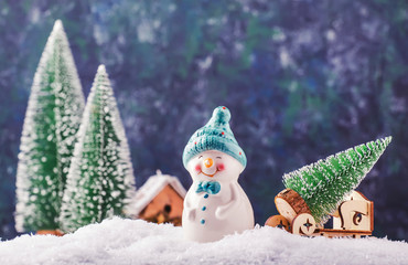 Merry Christmas and happy New Year composition with copy space. Little snowman carries Christmas...