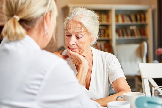 Female Doctor Cares In Depressive Elderly Woman