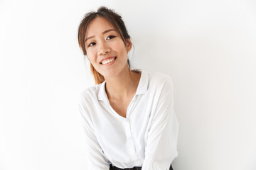 Attractive smiling asian woman standing isolated