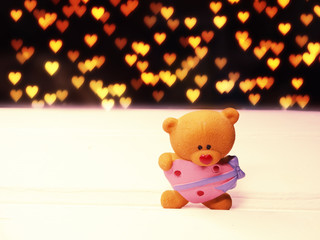 valentine's day composition of teddy bear and hearts