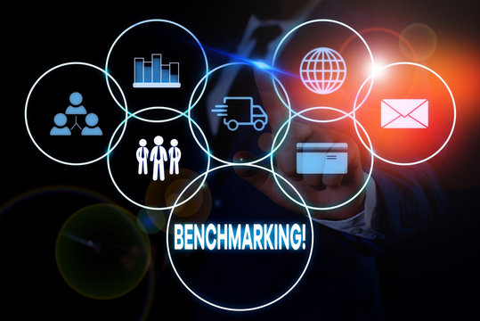 Text sign showing Benchmarking. Business photo showcasing evaluate something by comparison with standard or scores Male human wear formal work suit presenting presentation using smart device