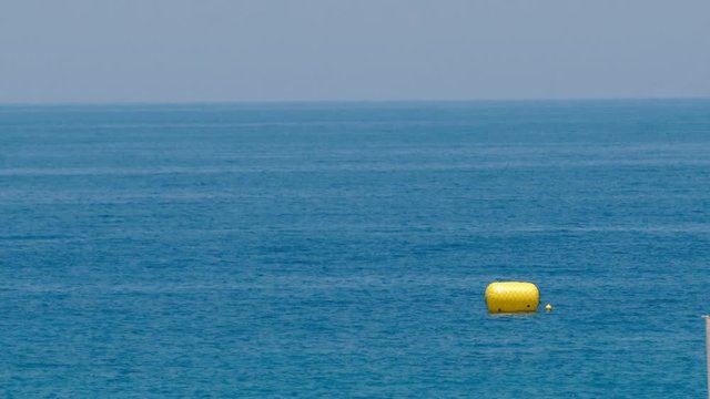 Yellow buoy on the sea waves background