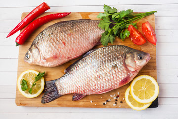 Raw carp fish with spices and vegetables for cooking. The view from the top. Copy space.