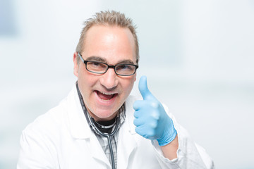male doctor with medical gloves shows thumbs up