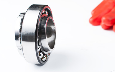 Ball bearing and gloves isolated on white background.Copy space