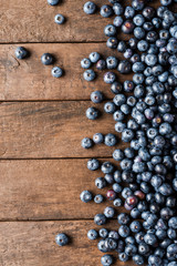 Overhead shot of fresh blueberries on wooden table. Top view