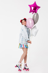 Image of joyful young woman smiling and holding balloons