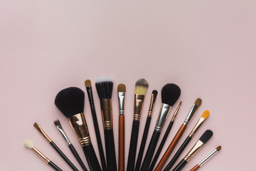 Top view arrangement with make-up brushes