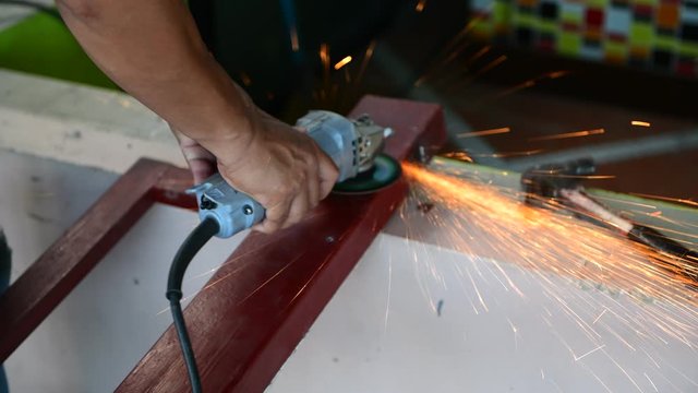 Grind makes sprinkles on a bar of iron