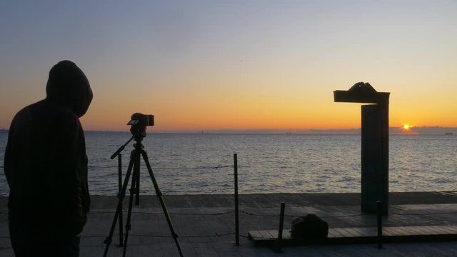 Hoodie wearing photographer takes photos Domus Solis in Odessa 