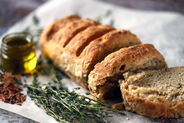 Fresh homemade italian bread with herbs and spices. Selective focus. Macro.