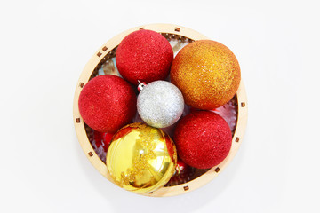 shiny multi-colored balls for the Christmas tree in a decorative basket for the New Year holiday