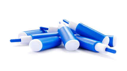 Blue lancets on a white background. Stack of blue lancets for a diabetes test on a white background. Blue blood lancets for measuring glucose in patients with diabetes isolated on a white background.