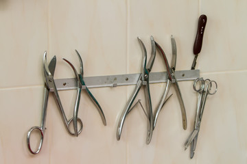 medical instruments hanging on a suspension mounted on a wall