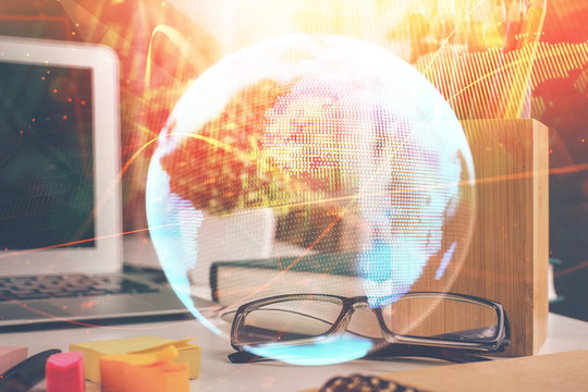 Business theme hologram with glasses on the table background. Concept of search. Double exposure.