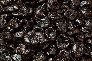 Background of delicious dried plums. Texture of food. Close up