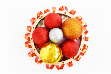 shiny multi-colored balls for the Christmas tree in a decorative basket for the New Year holiday