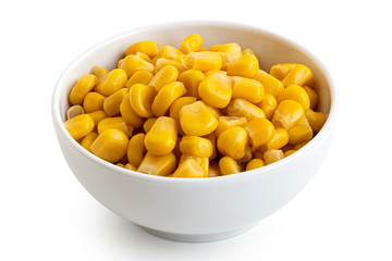 Canned sweet corn in a white ceramic bowl isolated on white.