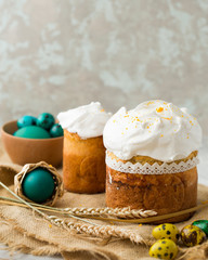 Easter cake with icing sugar, colorful painted eggs and spring flowers. Traditional Easter treats of Russia and Ukraine for Orthodox Easter. Easter symbols