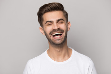 Fototapeta premium Overjoyed Caucasian man laughing at funny joke