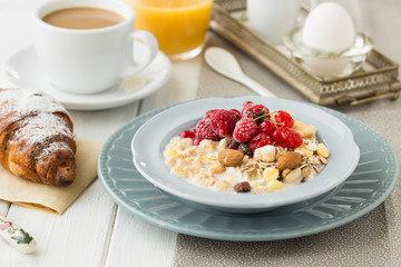 Breakfast oatmeal porridge with fruits berries and coffee cup. Oatmeal with strawberries and berry. Healthy breakfast Delicious homemade English breakfast concept for background.
