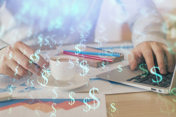 Forex graph with businessman working on computer in office on background. Concept of hardworking. Double exposure.