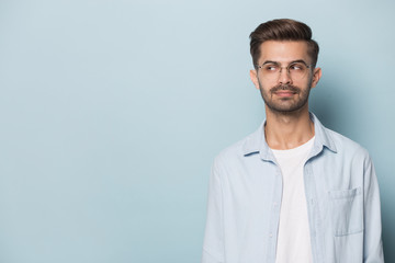 Pensive man in glasses look at blank copy space