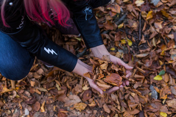 Outdoor autumn portrait of beautiful young woman with pink hair