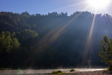 rainbow rays caused by reflection, refraction and dispersion of sun light. resulting in spectrum of light in the sky in the form of a multicoloured rays